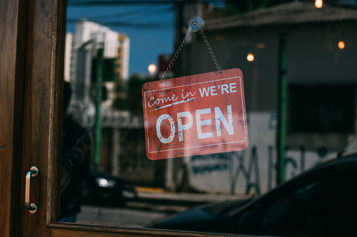 A business tore front with an open sign in the window.