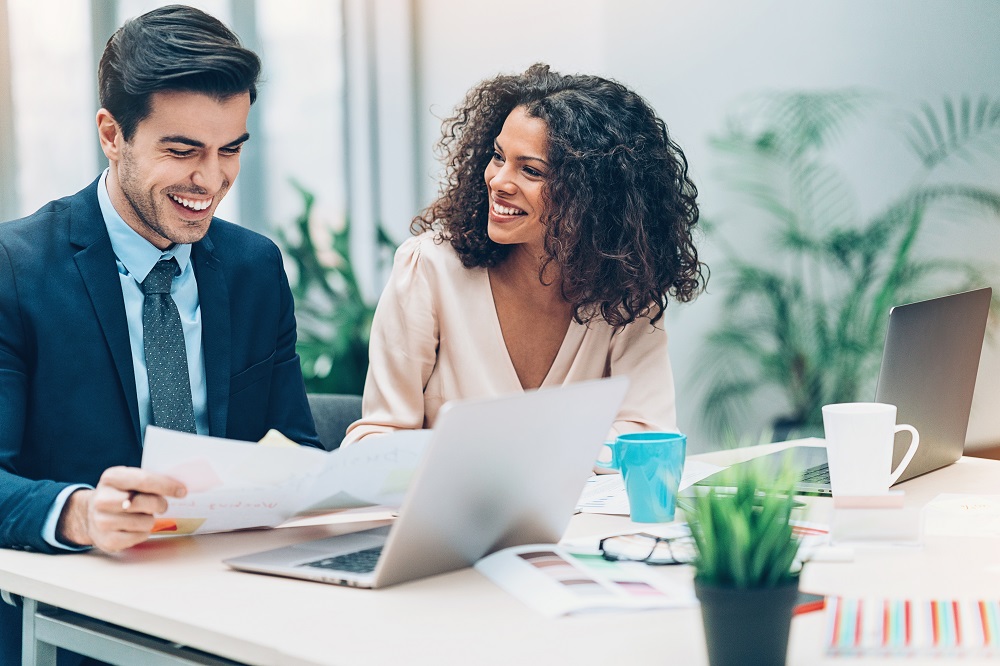 two business people looking at papers